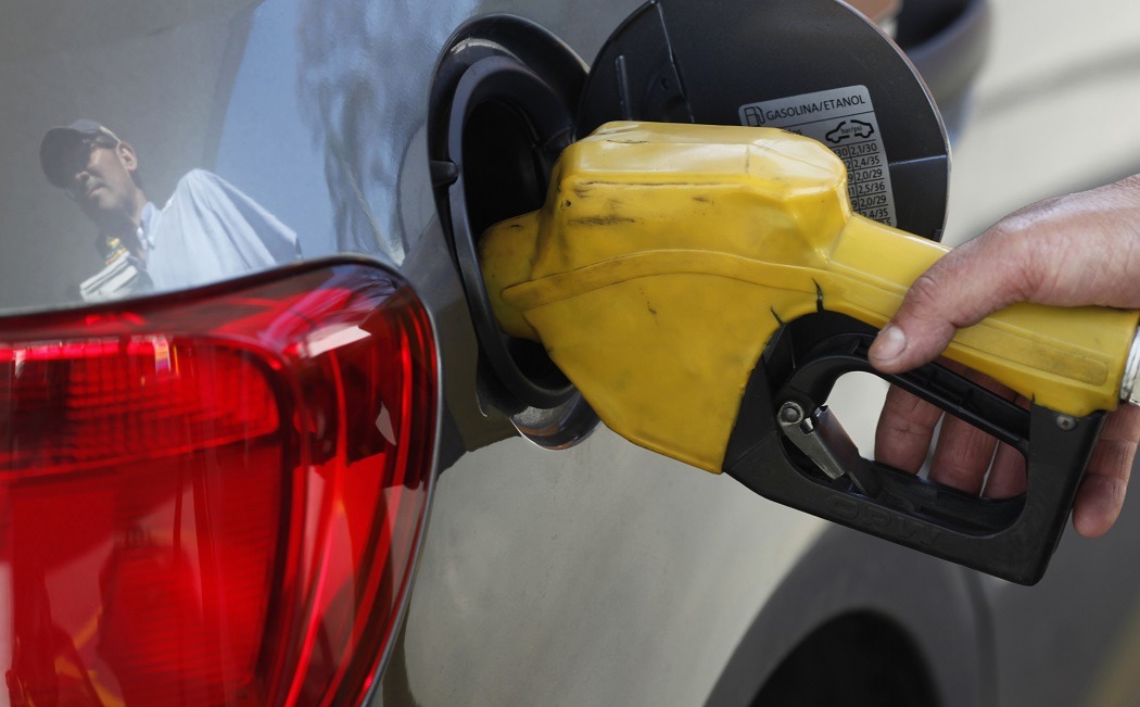 Funcionário de posto de gasolina abastece carro em São Paulo