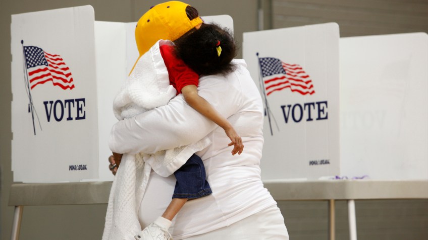 Com a filha no colo, moradora da Carolina do Norte vota na eleição presidencial dos EUA, em 2016 / Foto: Jonathan Drake - 8.nov.2016/Reuters