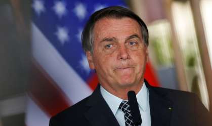 Bolsonaro em frente à bandeira dos Estados Unidos