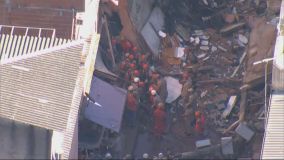 Bombeiros tentam tirar vítimas sob escombros de prédio