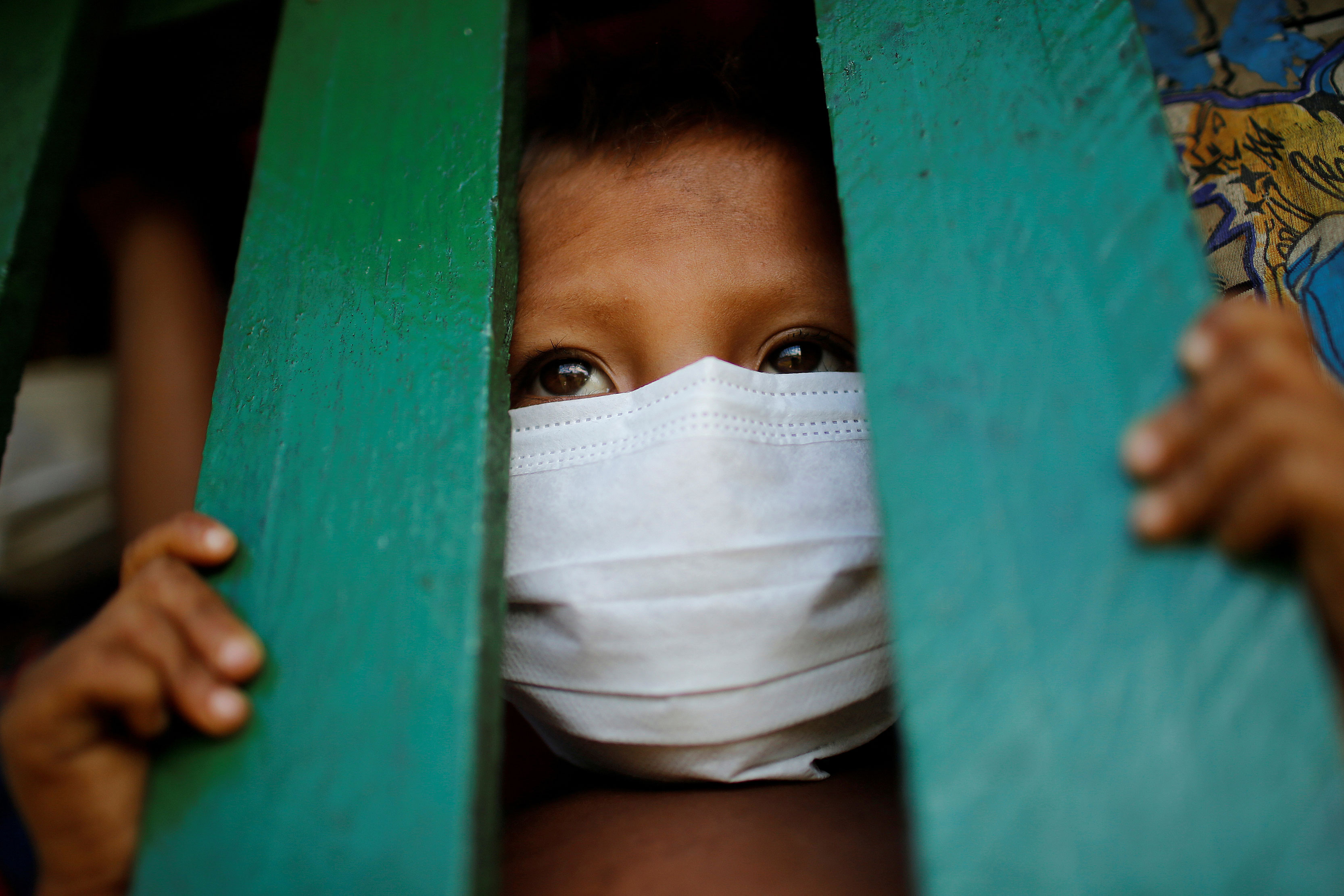 Criança yanomami usa máscara de proteção facial em Roraima