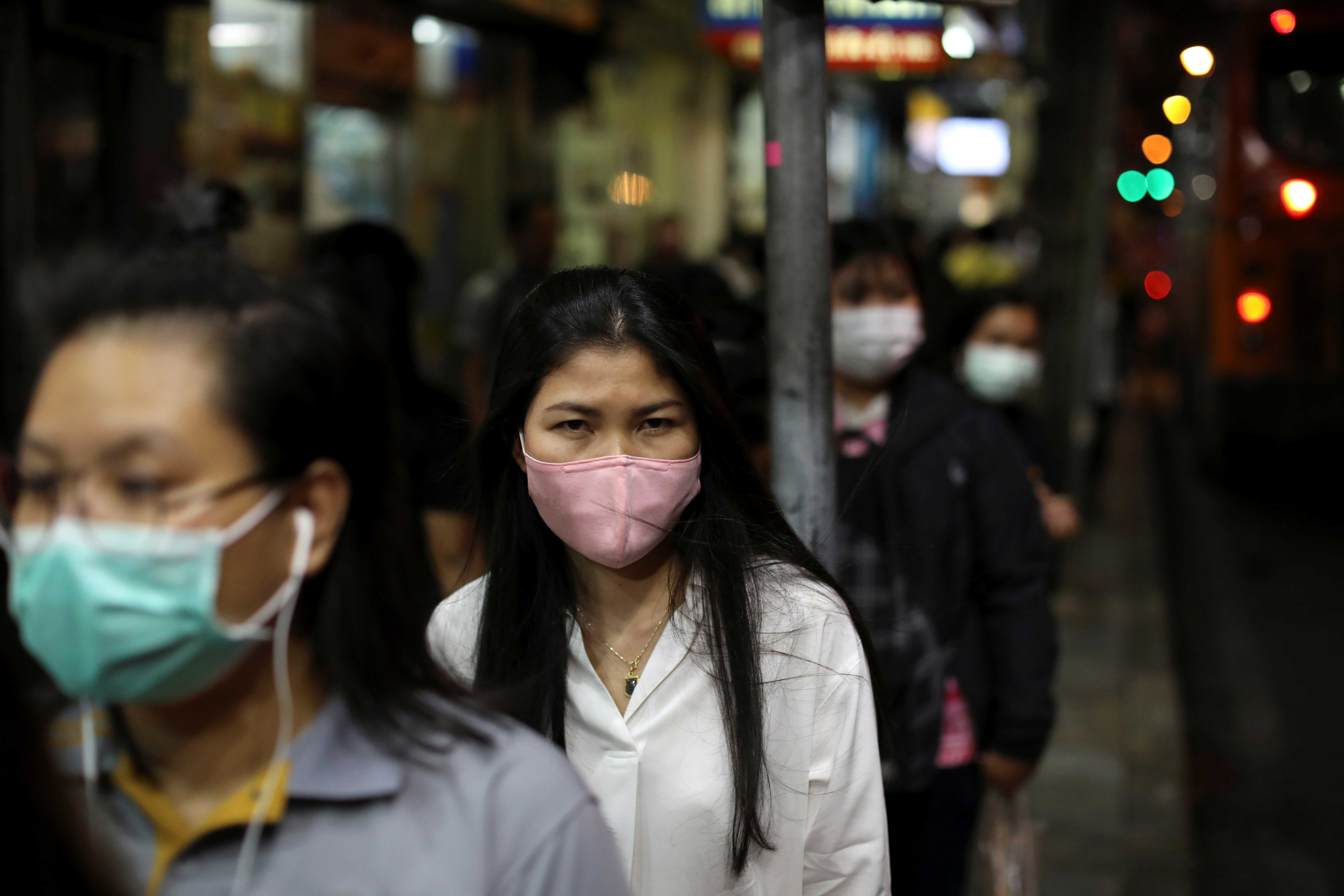Transeuntes usam máscaras para se protegerem de coronavírus em Bangkok