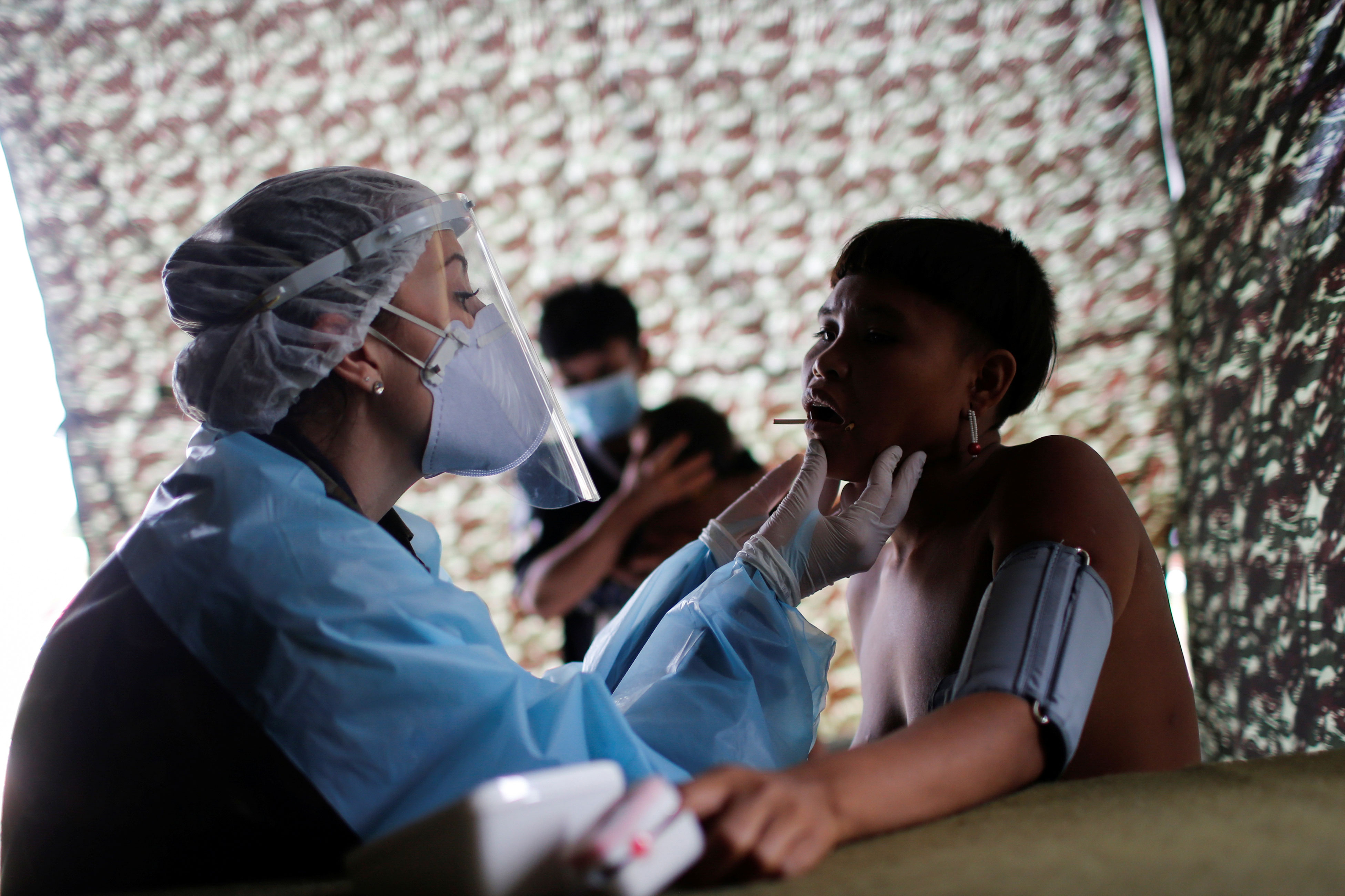 Médica das Forças Armadas examina mulher Yanomami em Alto Alegre, em Roraima