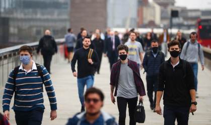 Pessoas andando de máscara nas ruas