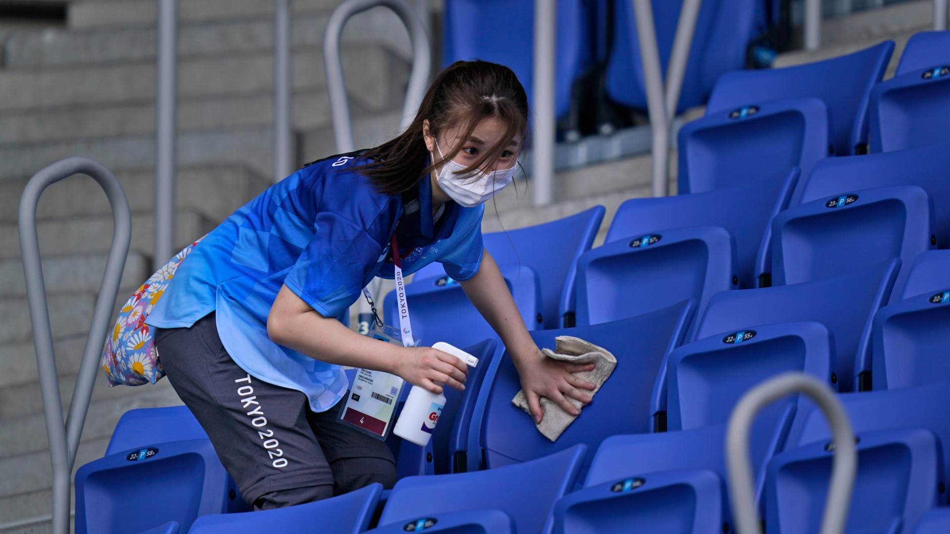 Mulher higieniza as instalações de uma arena de eventos nas Olimpíadas de Tóquio Mulher higieniza as instalações de uma arena de eventos nas Olimpíadas de Tóquio