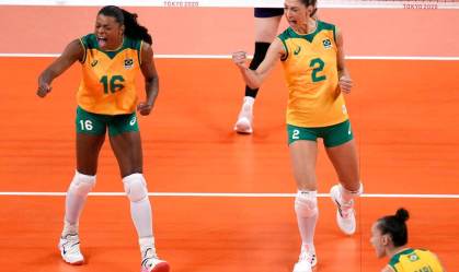 Jogadoras do Brasil vibram com punhos fechados em jogo de vôlei