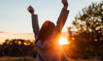 Young Woman Watching Sunset While Enjoying Nature