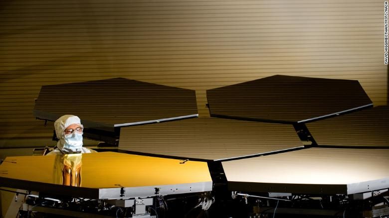 Scott Murray, técnico óptico da Ball Aerospace, inspeciona os primeiros segmentos de espelho primário de ouro durante a montagem. / Divulgação/David Higginbotham/NASA