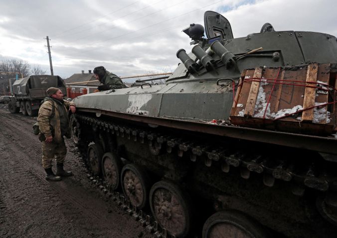 Tropas de uniformes sem insígnias são vistas ao lado de um veículo blindado com o símbolo "Z" pintado de lado, na aldeia separatista de Bugas, na região de Donetsk, na Ucrânia / Aleksander Ermochenko/Reuters