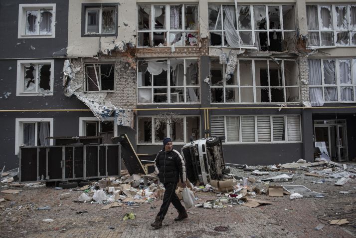 Homem caminha em meio aos escombros de um prédio habitacional em Bucha, na Ucrânia / Alexey Furman/Getty Images