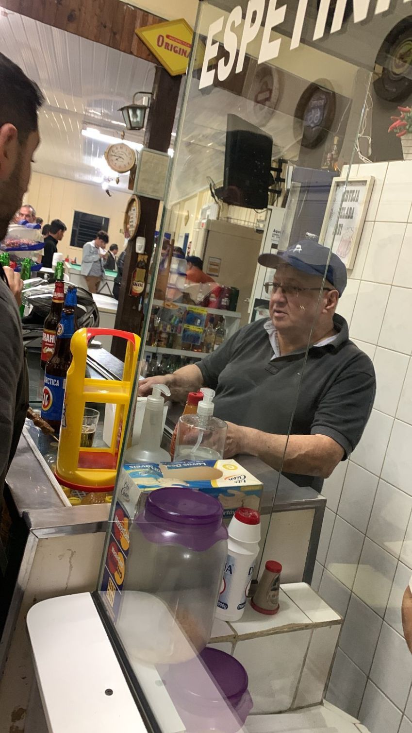 Dionísio atende clientes da Lanchonete Aquarius, em Curitiba, nesta quinta-feira (26), usando um boné da Jovem Dionísio. / Arquivo Pessoal