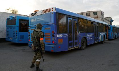 Buses carrying service members of Ukrainian forces who have surrendered after weeks holed up at Azovstal steel works arrive in Olenivka