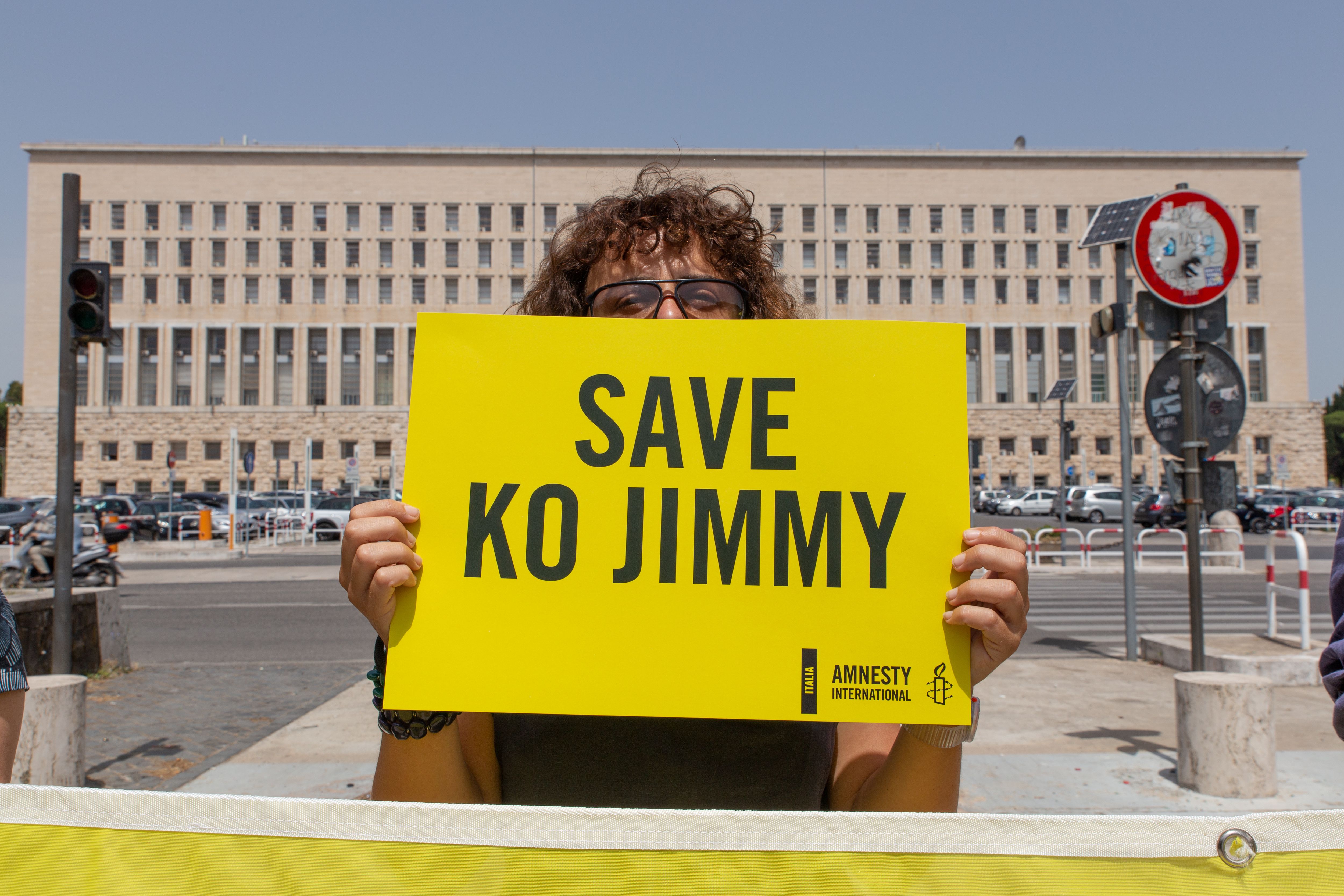 Activist holding placard with the name of Ko Jimmy to save