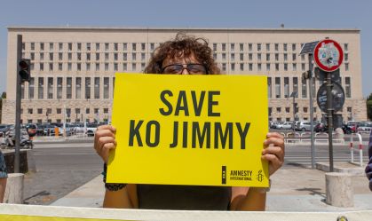 Activist holding placard with the name of Ko Jimmy to save