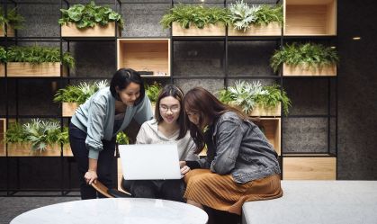Three women working together in a modern office