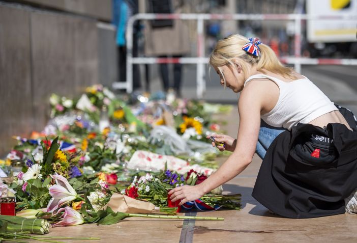 Mulher acende vela no lado de fora da Embaixada Britânica em Berlim após a morte da rainha Elizabeth II. / Christophe Gateau /picture aliança via Getty Images