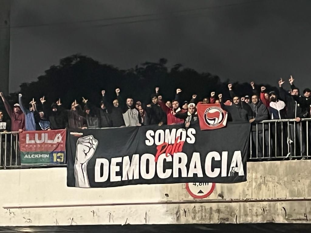 Gaviões da Fiel desfaz bloqueios de apoiadores de Bolsonaro em viagem para jogo do Corinthians. Torcedores estenderam faixa "Somos Democracia".