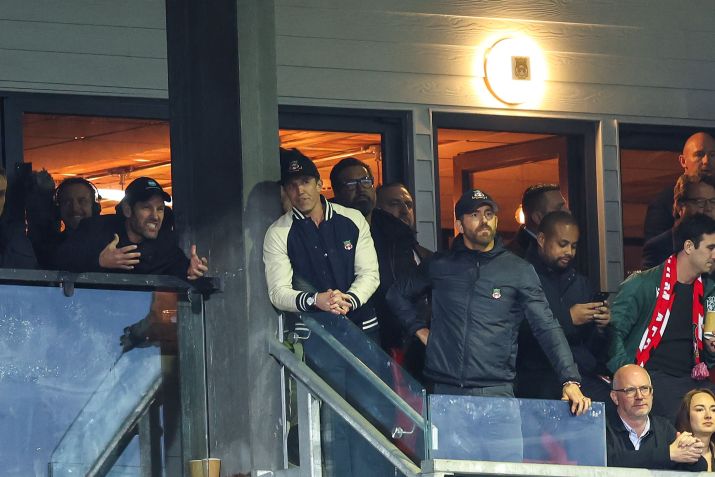 Paul Rudd, Rob McElhenney e Ryan Reynolds sofrem na arquibancada do Racecourse Ground / Matthew Ashton - AMA/Getty Images