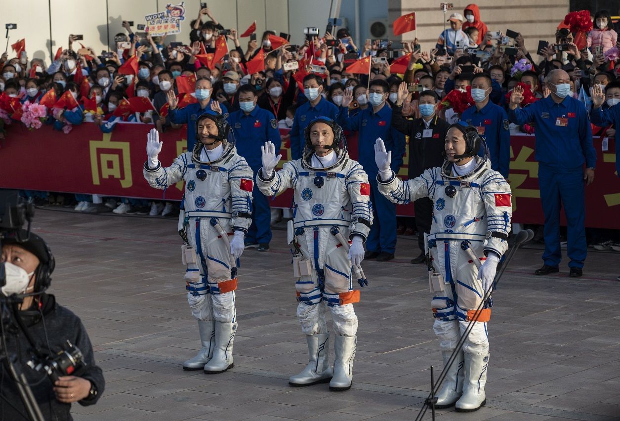 Gui Haichao, primeiro chinês civil a ir ao espaço (à esq.) ao lado de Zhu Yangzhu e o líder da missão, o veterano Jing Haipeng / Kevin Frayer/Getty Images