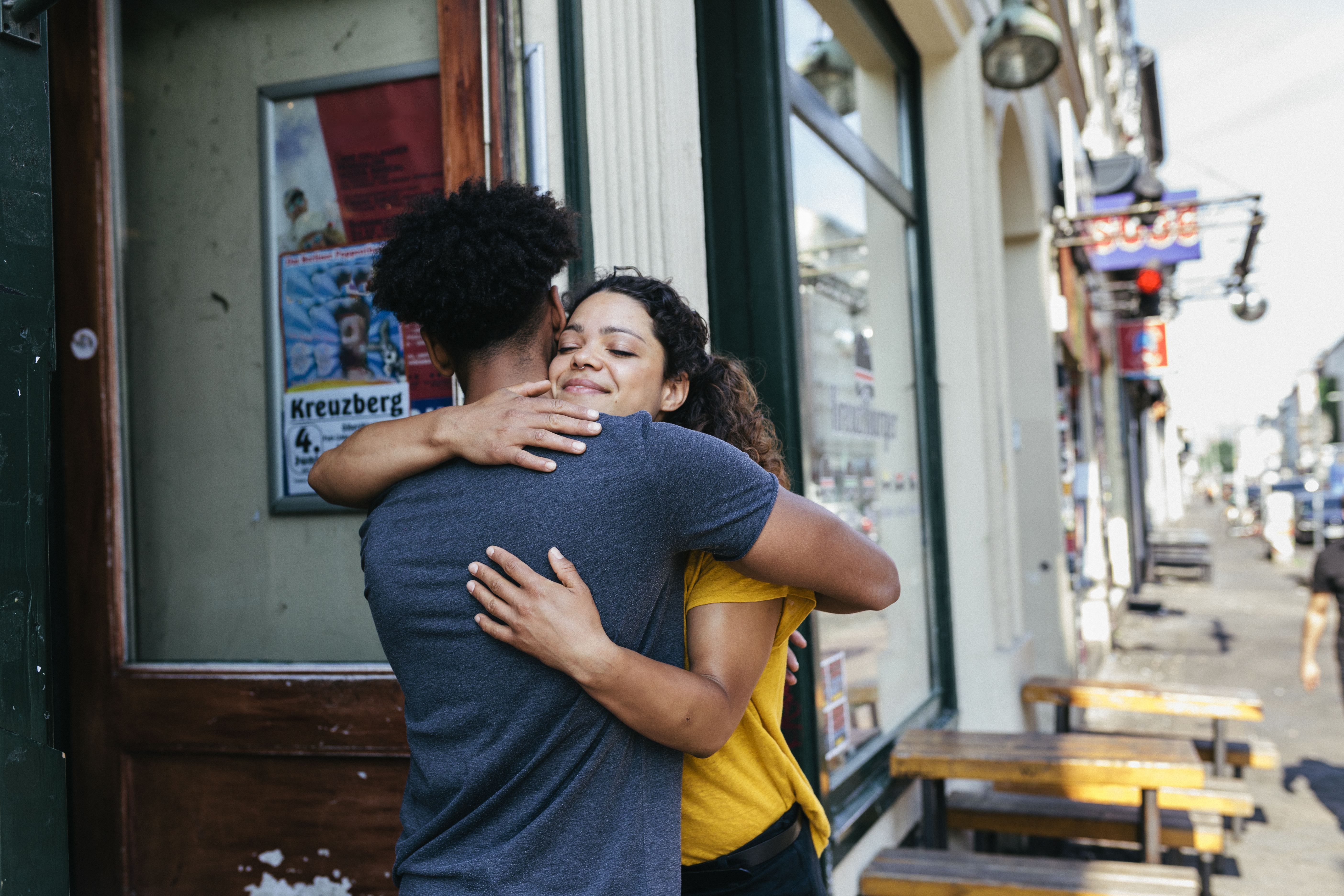 Friends Embracing Outside Restaurant
