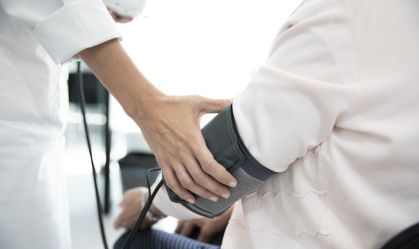 Measuring the pressure of senior woman