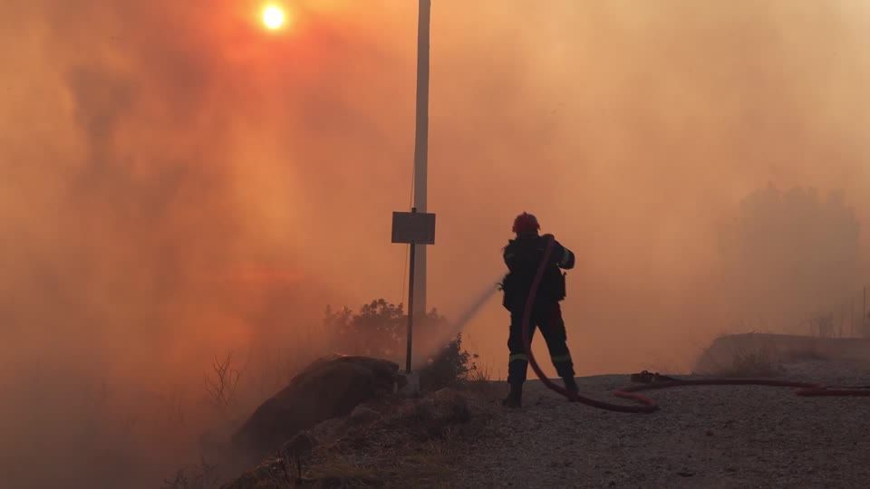 Wildfires burn homes southeast of Athens