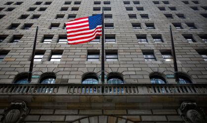The U.S. flag flies outside The Federal Reserve Bank of New York