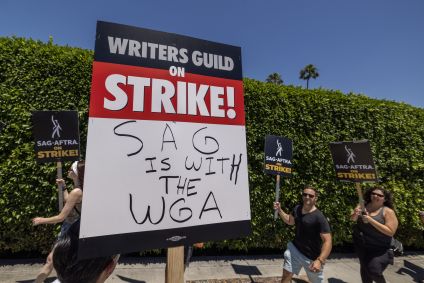 LOS ANGELES, CALIFORNIA - JULY 14: Members of the Hollywood actors SAG-AFTRA union walk a picket line with screenwriters outside of Paramount Studios on the first day of the actors' strike on July 14, 2023 in Los Angeles, California. Members of SAG-AFTRA, Hollywood’s largest union which represents actors and other media professionals, joined striking WGA (Writers Guild of America) workers in the first joint walkout against the studios since 1960. The strike could shut down Hollywood productions completely with writers in the third month of their strike against the Hollywood studios. (Photo by David McNew/Getty Images)