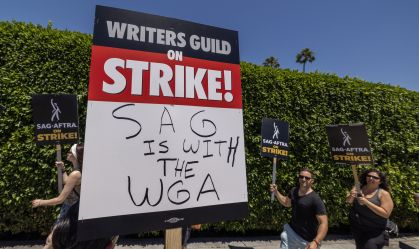 LOS ANGELES, CALIFORNIA - JULY 14: Members of the Hollywood actors SAG-AFTRA union walk a picket line with screenwriters outside of Paramount Studios on the first day of the actors' strike on July 14, 2023 in Los Angeles, California. Members of SAG-AFTRA, Hollywood’s largest union which represents actors and other media professionals, joined striking WGA (Writers Guild of America) workers in the first joint walkout against the studios since 1960. The strike could shut down Hollywood productions completely with writers in the third month of their strike against the Hollywood studios. (Photo by David McNew/Getty Images)
