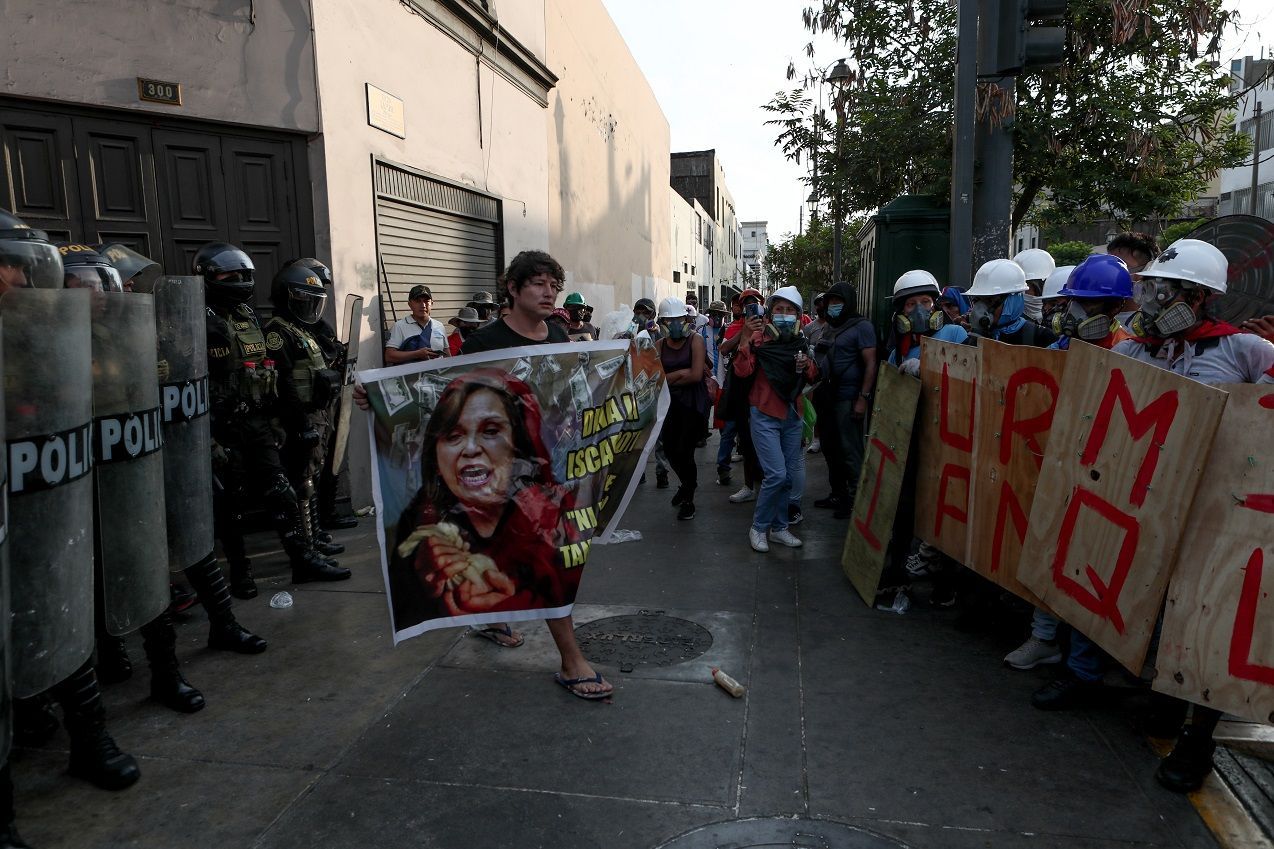 Protesters call a national strike in Lima during a march