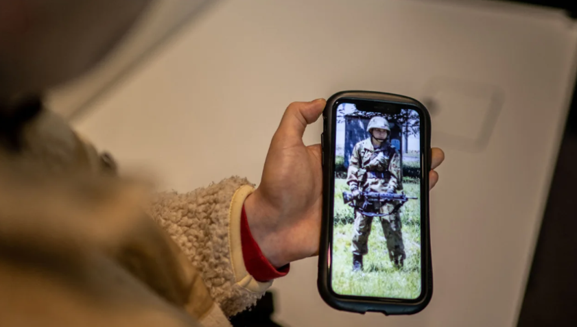 Rina Gonoi, ex-integrante da Força Terrestre de Autodefesa do Japão, verifica fotos antigas em seu telefone. / Philip Fong/AFP/Getty Images