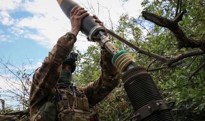Ukrainian service members fire a mortar at a front line near the city of Bakhmut