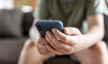 teenager boy is using smartphone at home - home schooling