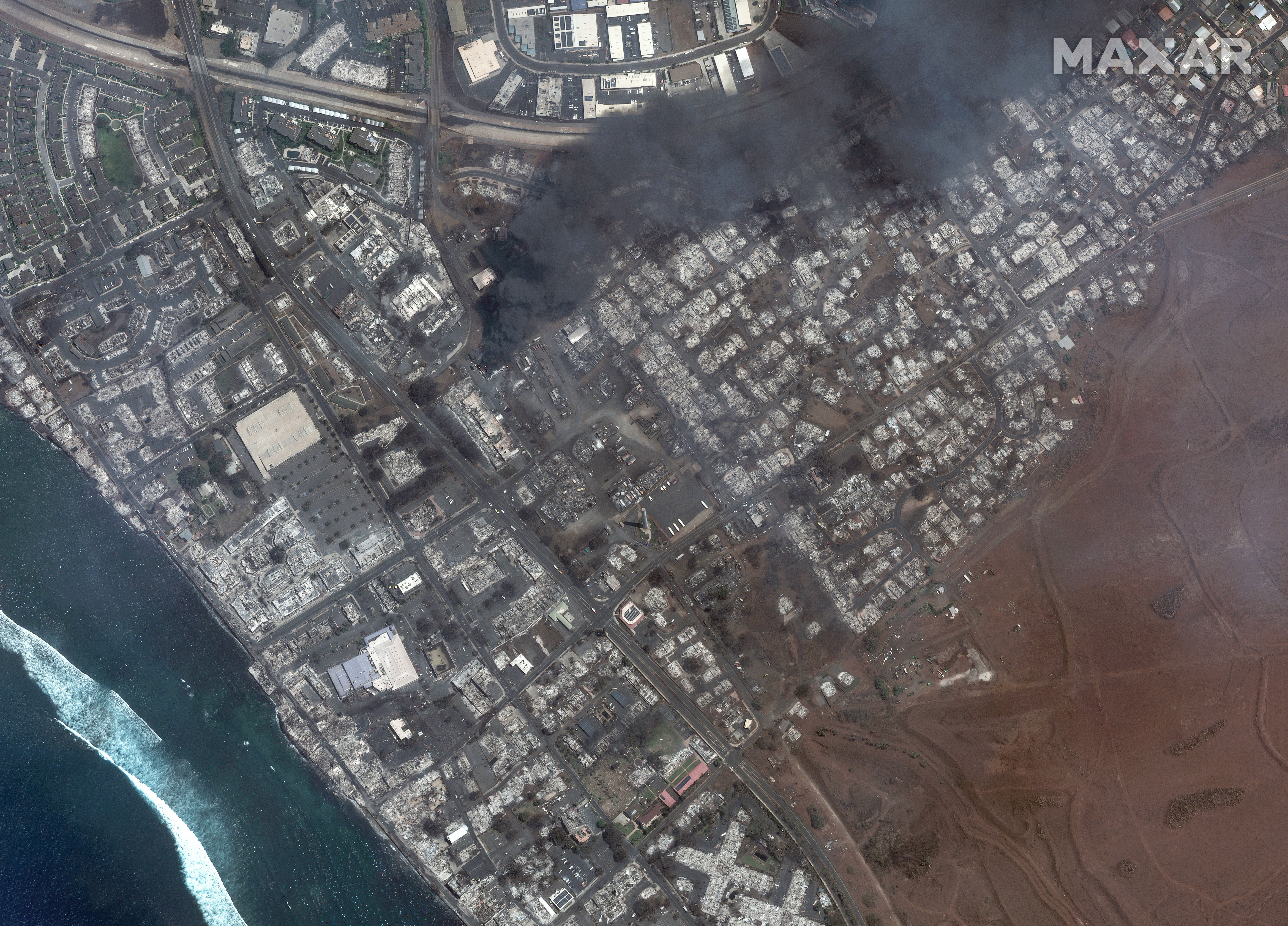 WILDFIRE LAHAINA, MAUI, HAWAII -- AUGUST 9, 2023:  04 Maxar satellite imagery showing total destruction of the Lahaina square and outlets after the Lahaina Wildfire, with one building still actively burning.  Please use: Satellite image (c) 2023 Maxar Tech