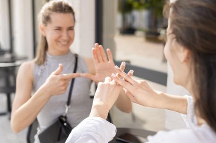 Duas mulheres se comunicando em Libras