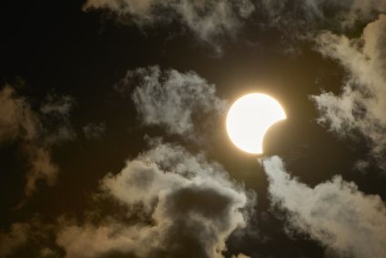 Eclipse solar parcial é visto por entre nuvens na cidade de Socorro, interior de São Paulo, na tarde deste sábado