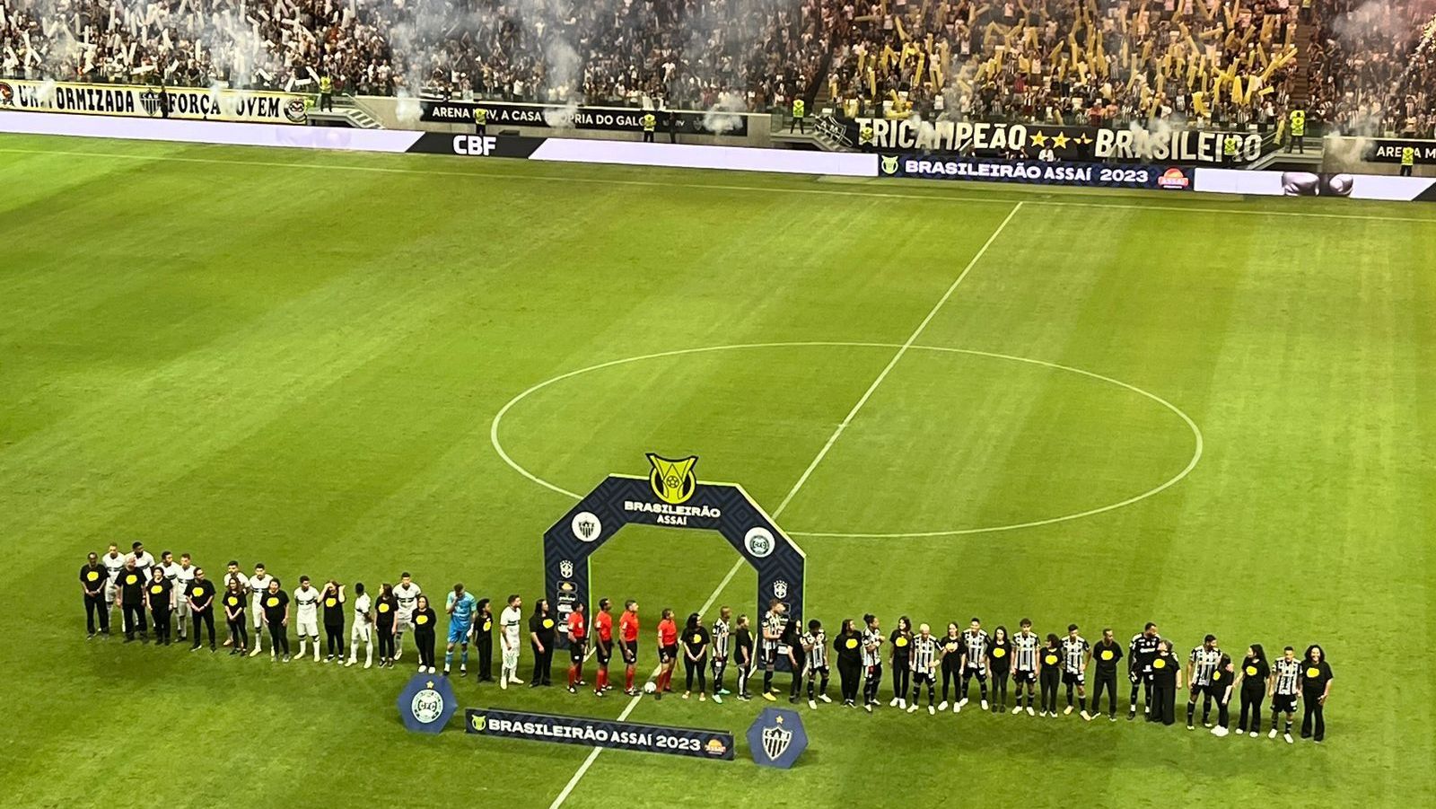 Jogadores do Atlético-MG posam ao lado de professoras antes do jogo contra o Coritiba pelo Campeonato Brasileiro na Arena MRV