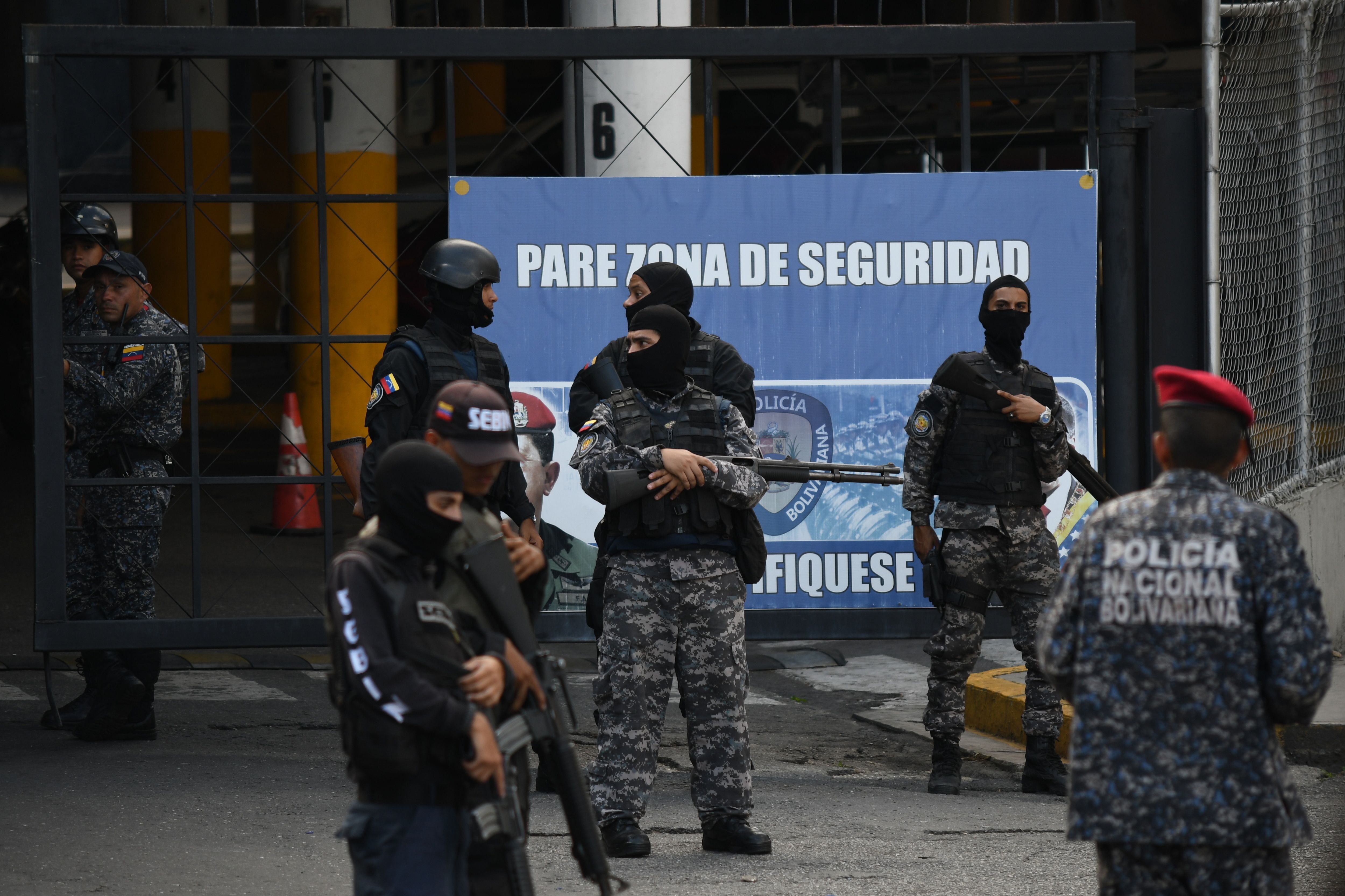 Sebin officials outside Helicoide prison during riots.