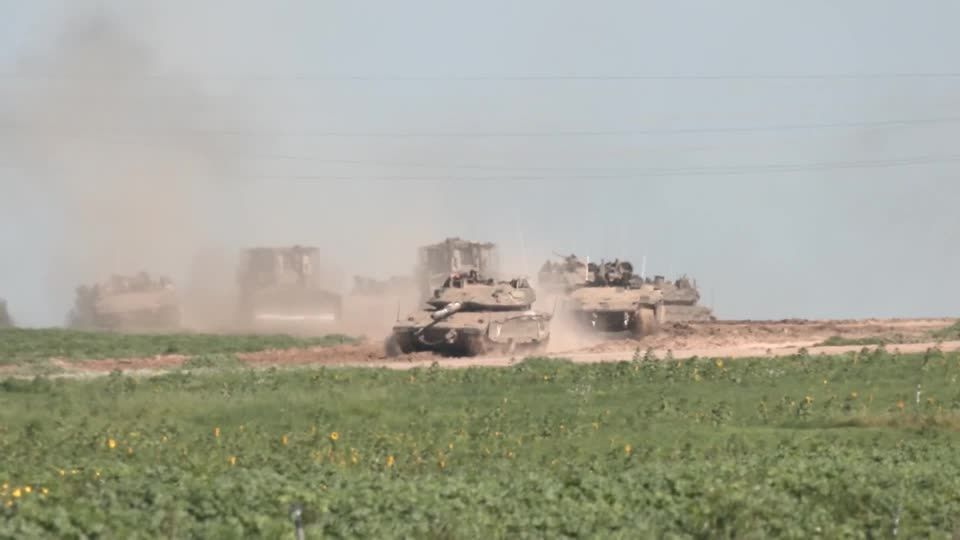 Israeli forces along Gaza border as thick smoke billows from the enclave