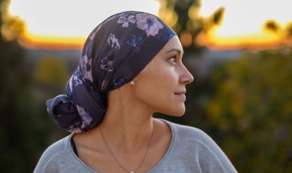 Hopeful and confident woman with cancer watching sunset