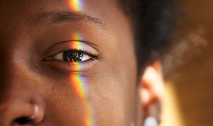 Close up photo of Multi Coloured Light Falling On Human Eye.