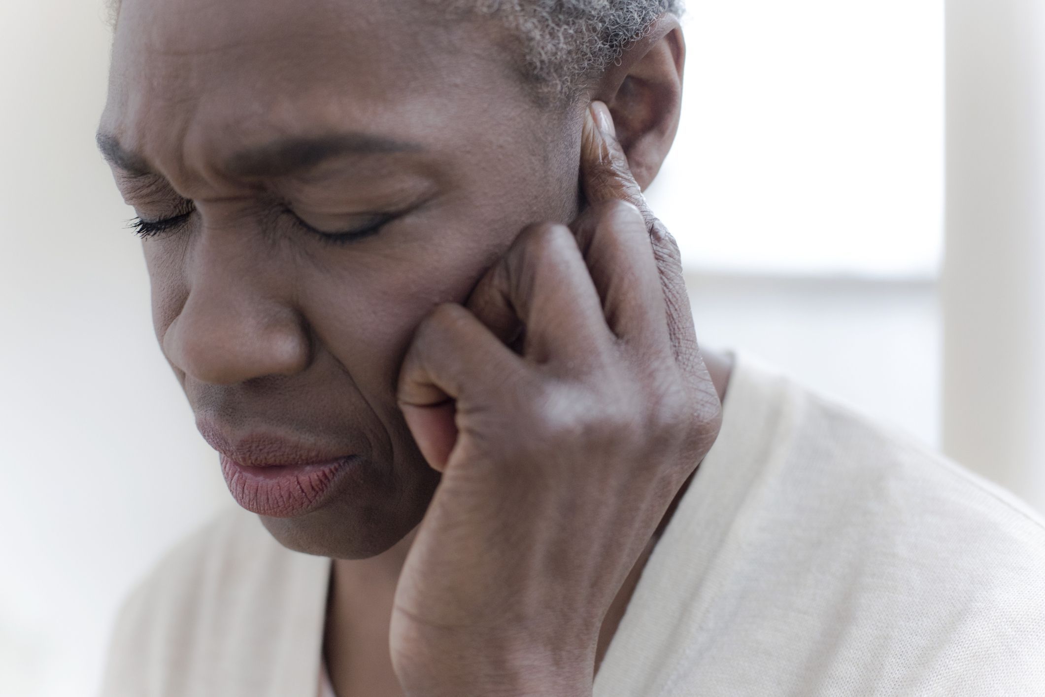 Woman touching ear