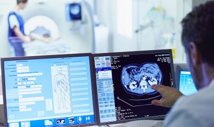 Doctor running CT scan from control room