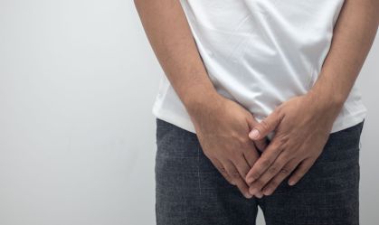 Hands covering the crotch of trousers (Gender Disease Concept)