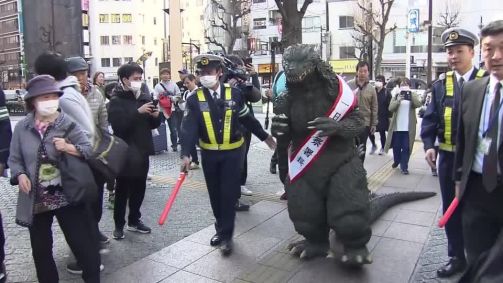 Godzilla patrulha ruas de Tóquio em ação sobre segurança no trânsito