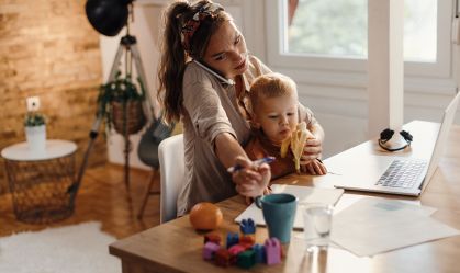 Multi-tasking mother taking care of her small son while working