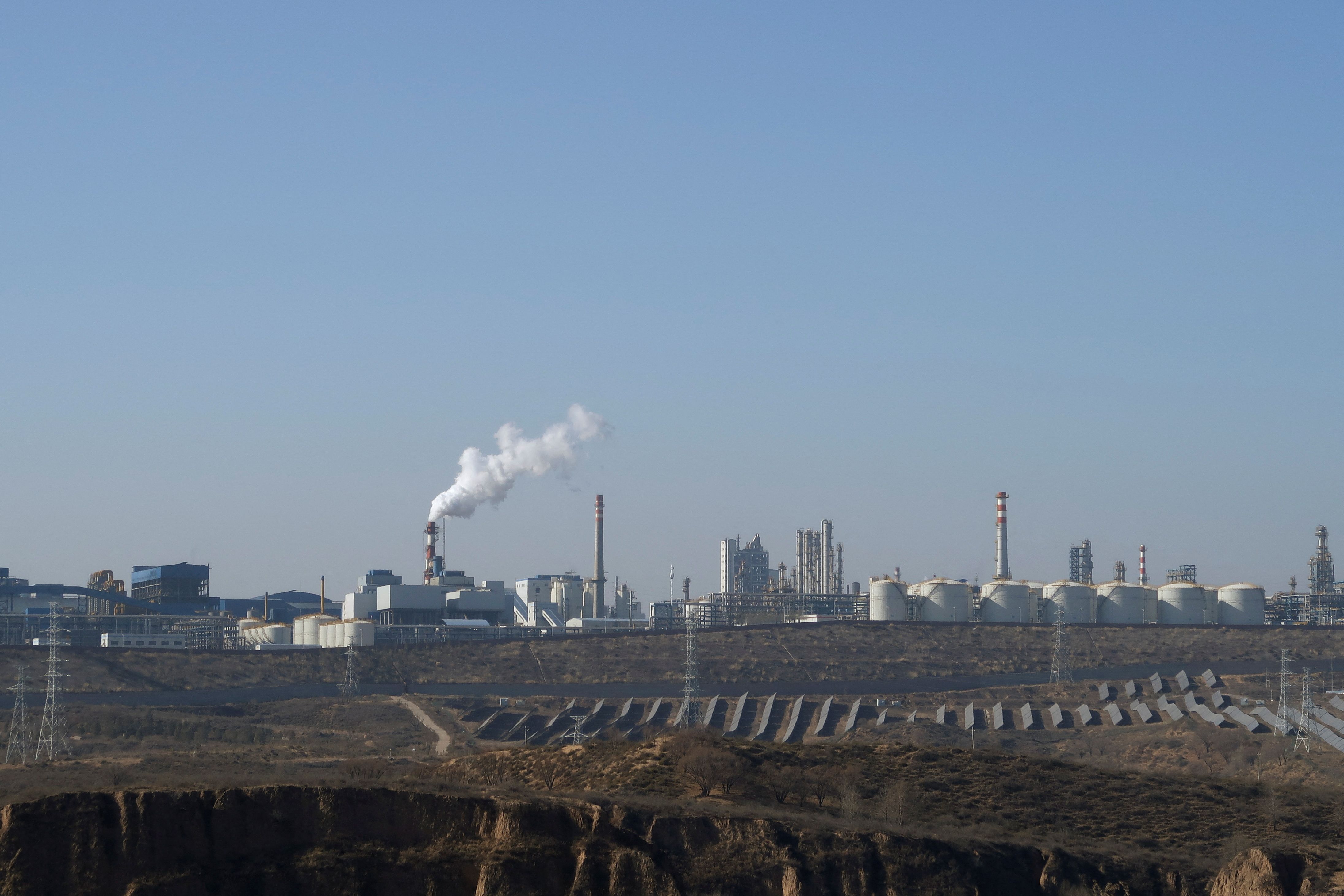 FILE PHOTO: Solar panels lie in front of factories at Jinjie Industrial Park in Shenmu