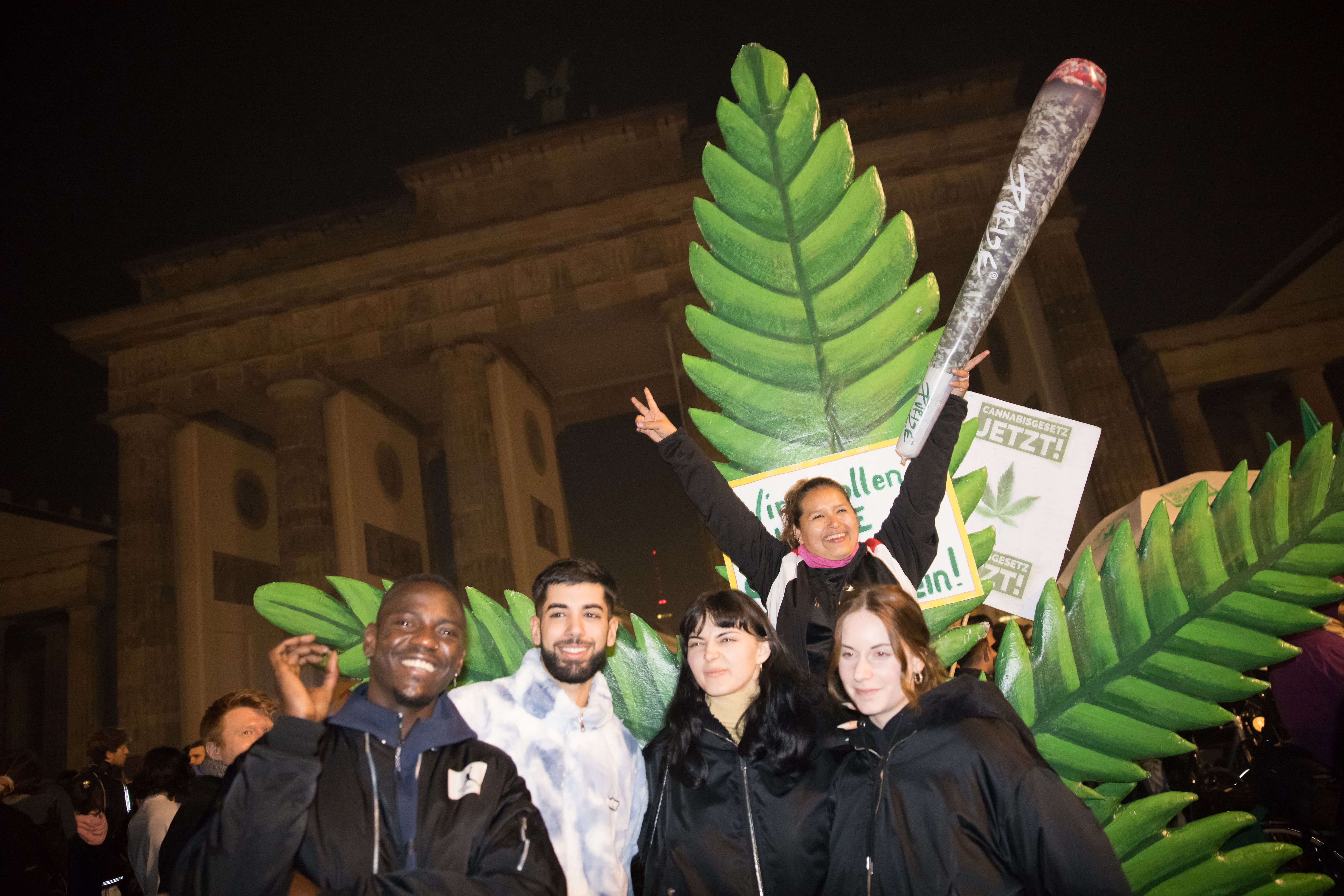Entusiastas da cannabis fumam baseados legalmente no Portão de Brandemburgo, em Berlim, pouco após a meia-noite de 1º de abril de 2024, quando entrou em vigor a legalização parcial da maconha na Alemanha.