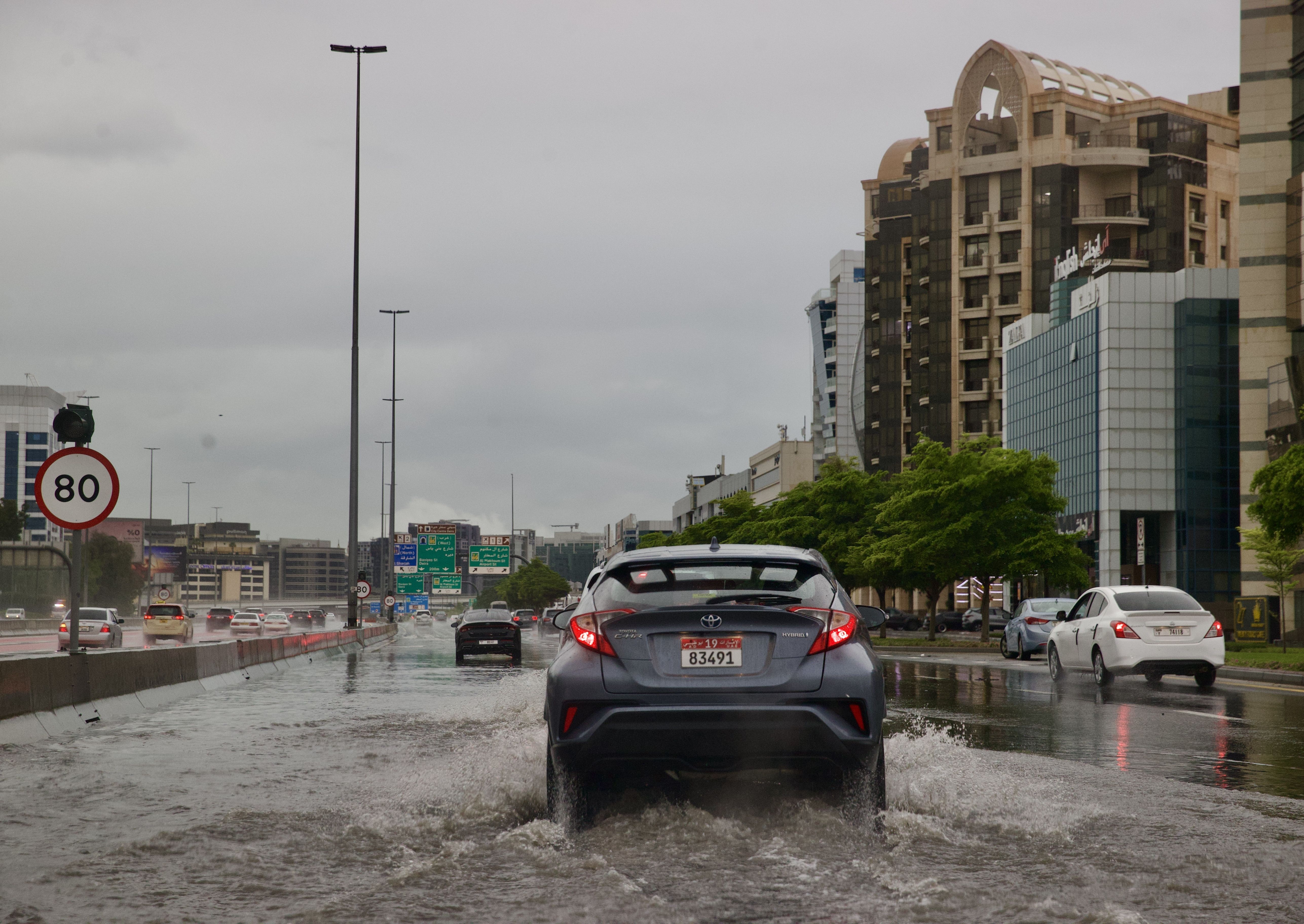 Carros atravessam estradas inundadas devido a fortes chuvas, já que as condições climáticas adversas afetam negativamente a vida diária em Dubai, Emirados Árabes Unidos, em 15 de abril de 2024/ Stringer/Anadolu via Getty Images