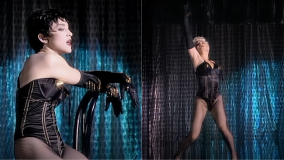 Figurino de Madonna no videoclipe da música &quot;Open Your Heart&quot;, de 1986; ponta da parte dos seios no maiô tem fitas, de referência burlesca